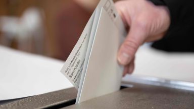 A man votes in an election 